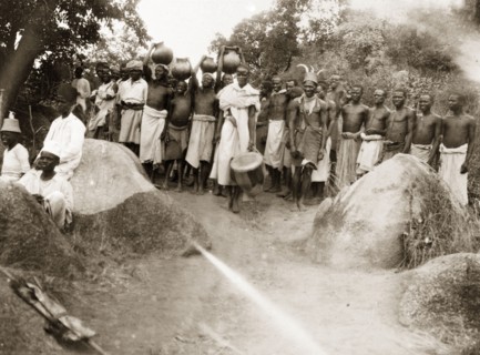 Safari porters gather for a feast. African porters await a feast before setting off on a 30-day