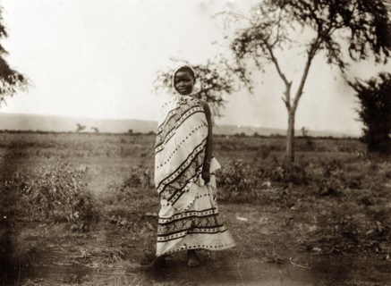 Kavirondo girl. Portrait of a young Kenyan girl dressed in a patterned wraparound robe that covers