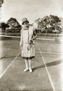 Margaret trotter plays tennis. Portrait of Margaret Trotter in her sporting whites, posing racquet