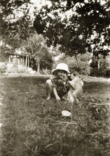 When you were about 5 1/2. A young Charles Trotter squats down to play with his pet Vervet monkey