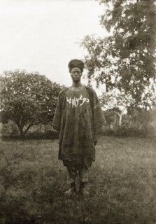 Nigerian policeman. Portrait of a Nigerian policeman dressed in a robe with white writing on his