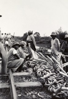 Banana sellers, Uganda. Banana sellers hope to attract passing trade beside a railway track and