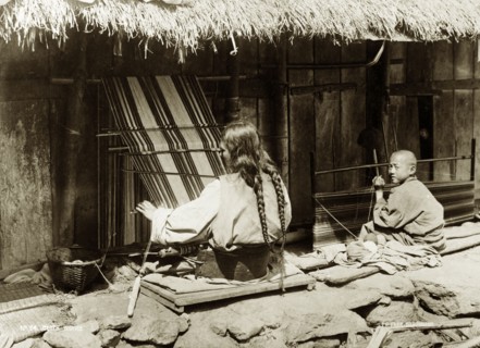 Two weavers, India. Two weavers, a woman and a child, at work on outdoor looms near Darjeeling.