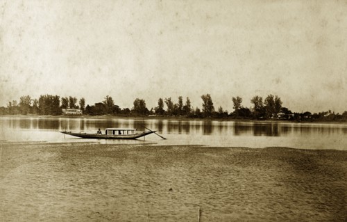 Hooghly River, West Bengal. A lone fishing boat rests on the calm waters of the Hooghly River. West