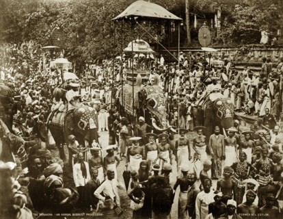 Buddist perahera in Ceylon. Crowds of people pack the streets at an annual Buddhist perahera