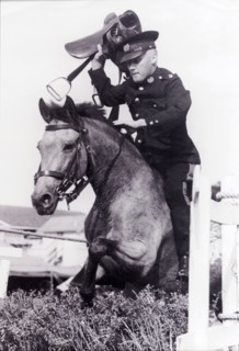 Leslie Slater holds his breath. Uniformed British police officer, Leslie Slater, holds his breath