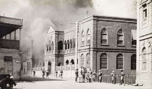Riot damage in Aden, 1947. Smoke engulfs a building in the Jewish quarter of Aden, during the Arab