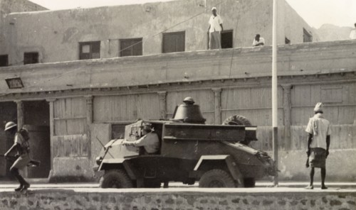 Armoured vehicle patrolling Aden during riots, 1947.. A light armoured vehicle is driven along a