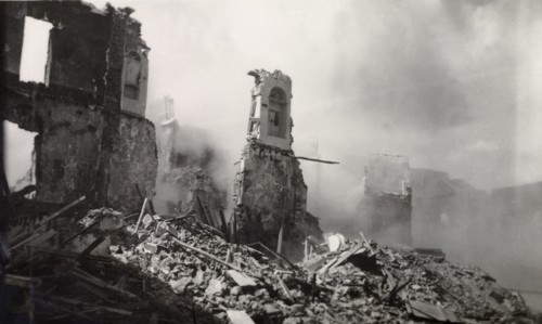 Aftermath of Arab riots in Aden, 1947. The smoking ruins of a building reduced to rubble in the