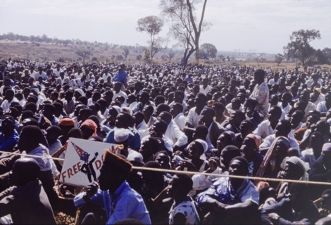 Crowd at United National Independence Party rally. A crowd of Zambian supporters sit and watch a