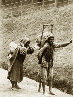 Nepalese labourers. A barefoot Nepalese couple, labelled in an original caption as 'coolies',