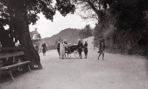 The mall', Mussoorie. Uniformed servants surround a rickshaw at 'the mall', a road junction at the