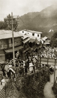 Bazaar at Mussoorie, India. Crowds bustle past a line of ramshackle buildings at a bazaar in