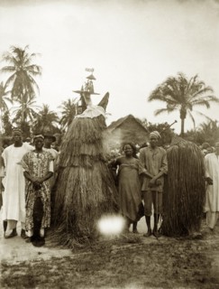 Tassled juju costumes. Two juju practioners dressed in tassled costumes designed to cover their