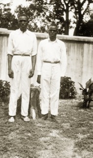 Domestic servants in a garden. Portrait of two male domestic servants, 'Joe' a cook and 'Sam' a