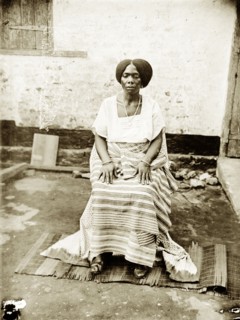 Portrait of a seated Nigerian woman. Portrait of a Nigerian woman, seated and wearing traditional