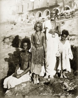 Portrait of a Bischarin family. Group portrait of two adult men and two children, possibly boys.