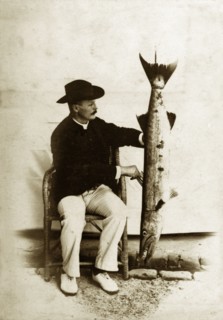 Prize fish, Andaman Islands. A European man poses proudly for the camera, displaying a large,