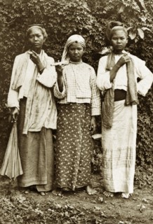Three Burmese women. Outdoors portrait of three young Burmese women wearing traditional dress.