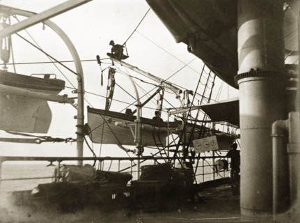 Lifeboats on RIMS 'Investigator'. A crew member perches precariously above a lifeboat on board RIMS