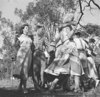 Square dance rehearsal. A group of dancers couple up to practice their routine for a square dance