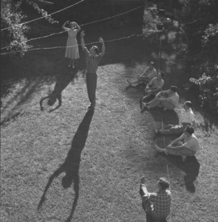 Dance rehearsal, Kenya. The long shadows of two ballet dancers extend across a lawn at a practice