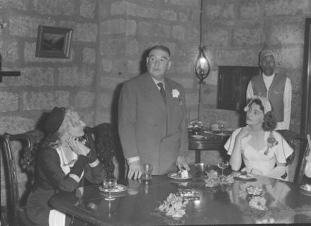Genniclift-Thompson wedding. A middle-aged man stands to deliver his speech to the table at the