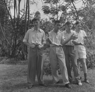 Cabaret practice. Four young men strike a pose as they practice their cabaret routine for a square