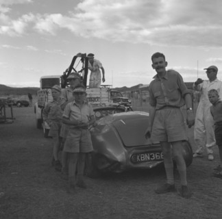 Recovery of a Connaught racing car. A curious group of onlookers gathers to watch the recovery of a