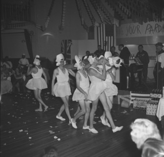 Men in tutus. A group of men bare their legs in tutus as they perform a skit as male ballerinas at