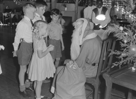 Father Christmas distributes gifts. Father Christmas distributes gifts to children at a Christmas
