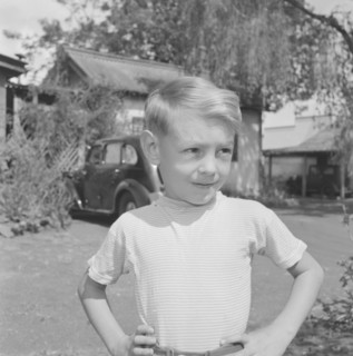 Dusty Miller's son. Portrait of one of Dusty Miller's two sons, standing hands on hips outside the