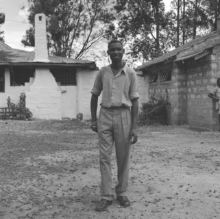 Off-duty Kenyan bartender. An off-duty Kenyan bartender relaxes with a cigarette, dressed in casual