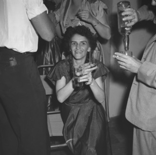 Last night of 'Cinderella'. A woman enjoys herself, drinks in hand, at a party being held for the