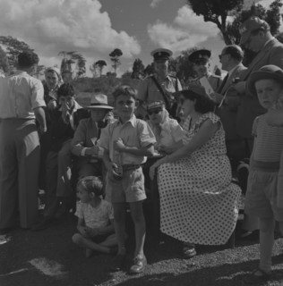 Soap box derby. A group of 'officials' wait patiently at the finish line for contestants in a soap