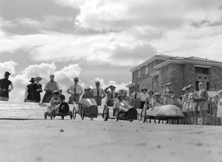 Soap box derby. Four young contestants wait tensely on the starting line for their cue to begin a