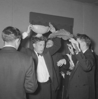 Rugby team antics. Members of a rugby team dressed in tuxedos fool around at the Mogambo Club.