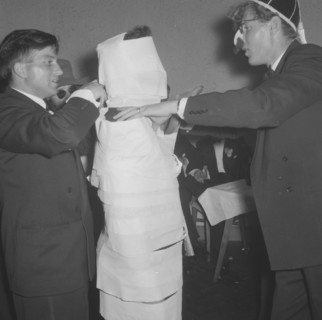 The Mogambo mummy. Members of a rugby team dressed in tuxedos fool around at the Mogambo Club. One