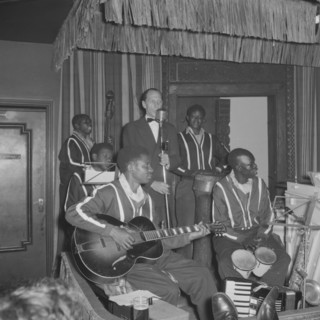 Band at the Equator Club. A European singer performs with a band of African musicians on stage at