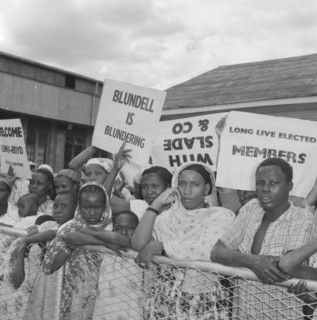 Kenyan demonstrators. A peaceful crowd of Kenyan demonstrators are held back behind an airport