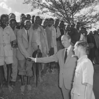 Lennox-Boyd visits Fort Hall. Publicity shot of Alan Tindal Lennox-Boyd (1904-1983) shaking the