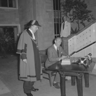 Lennox-Boyd opens City Hall. Alan Tindal Lennox-Boyd (1904-1983) signs the visitors book at the