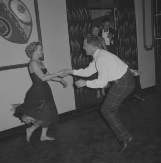 Dancing at the Equator Club. A couple dance energetically at the Equator Club. The woman, identifed