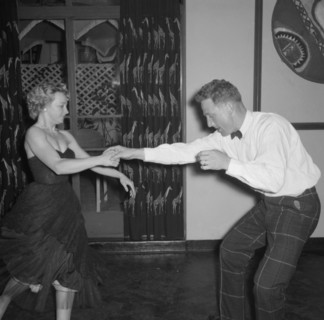Dancing at the Equator Club. A couple dance energetically at the Equator Club. The woman, identifed