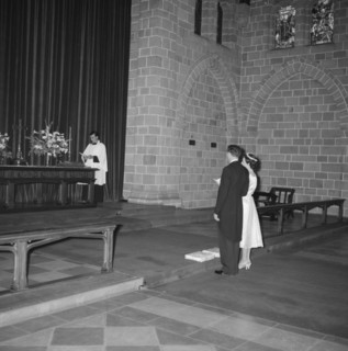 Coltart wedding. The Coltart couple read from a prayer book before the altar at their wedding