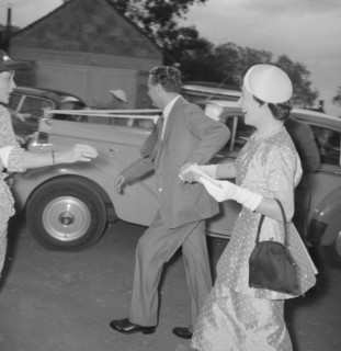 Newlyweds make a dash. The newlywed Coltart couple make a dash for their wedding car under a shower