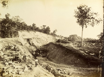 Railway construction site. Labourers at work on a construction site, landscaping a bank of earth to