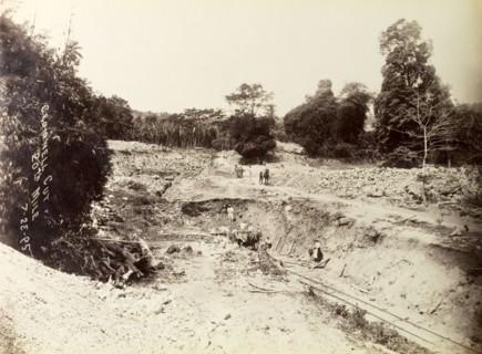 Railway construction site. Labourers at work on a construction site, landscaping a bank of earth to