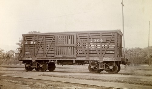 Jamaica Railway wagon. A closed railway wagon inscribed 'J. RY.2004', sits on rails at a siding.