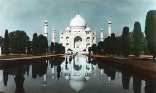 The Taj Mahal, circa 1925. View of the Taj Mahal, reflected in the central canal running up to its